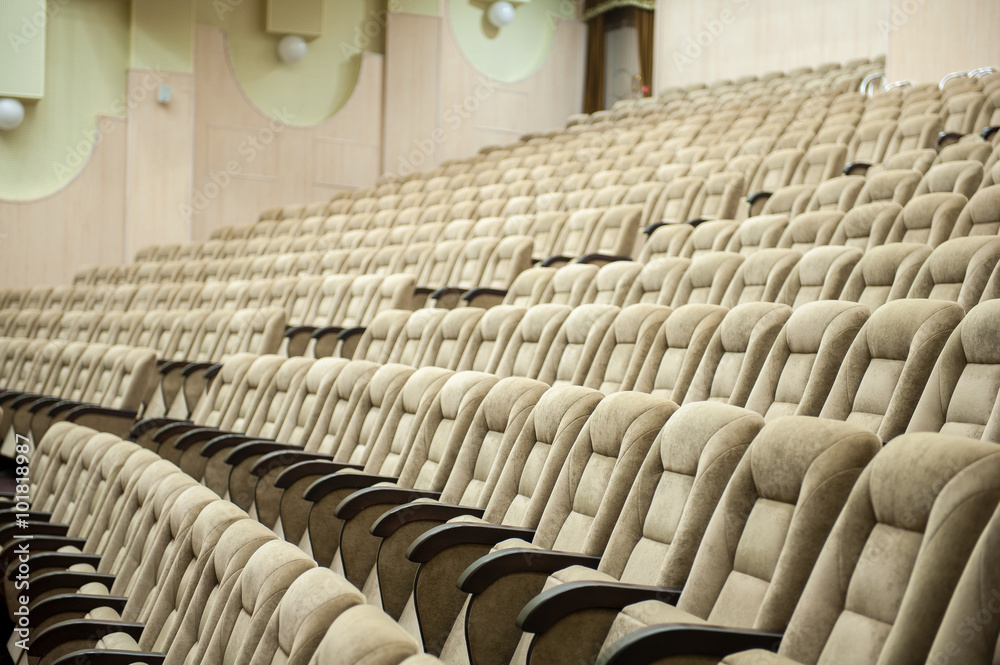 Obraz premium Empty auditorium with beige chairs, theatre or conference hall