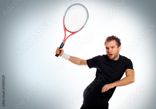 Tennis player hits the ball with the racket © Zarya Maxim
