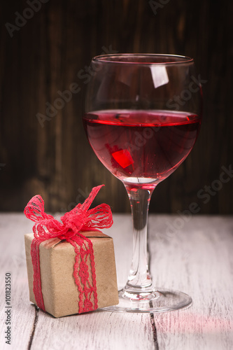 Gift box and glass of rose wine. Vintage style. Selective focus