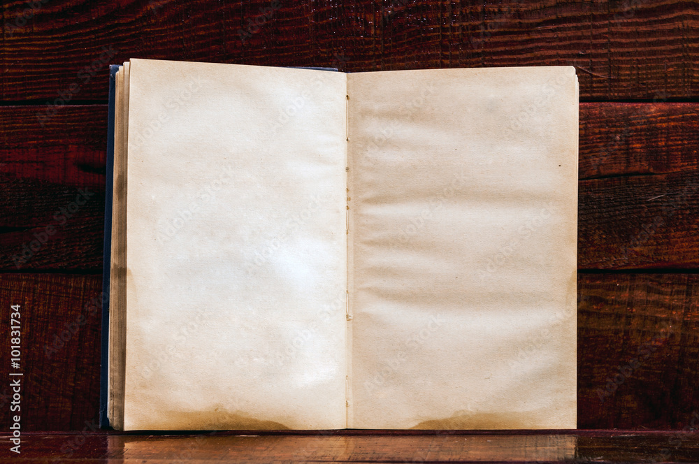 Fotografie Vintage book, open, on old wooden table.