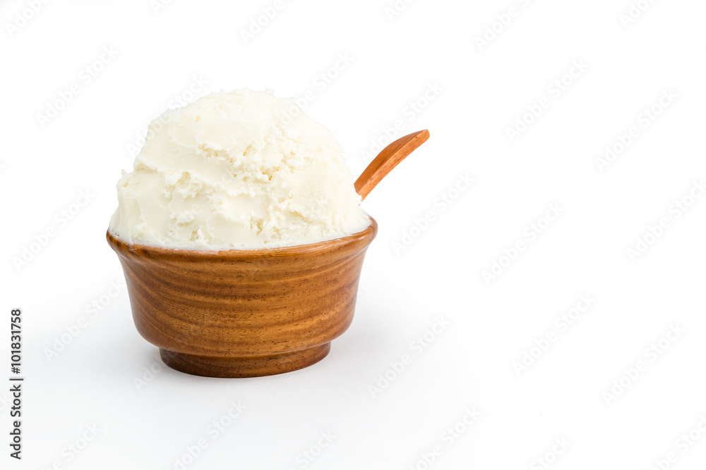 Shea butter in the wooden bowl, clean white background. Shea butter in the wooden bowl, clean white background.