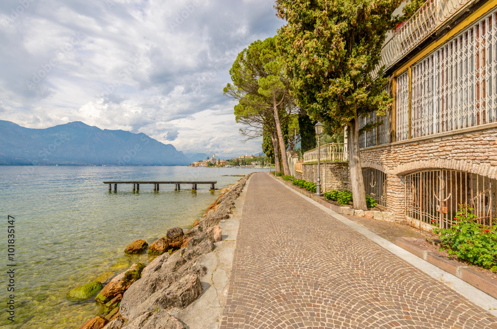 Walkpath along beautiful peaceful lake Garda, Italy