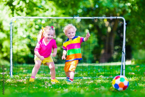 Kids playing football in school yard © famveldman