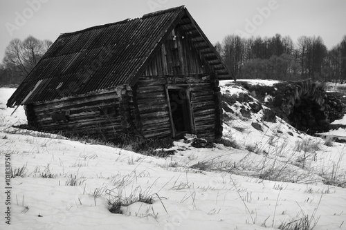 black and white photo of an abandoned hut.