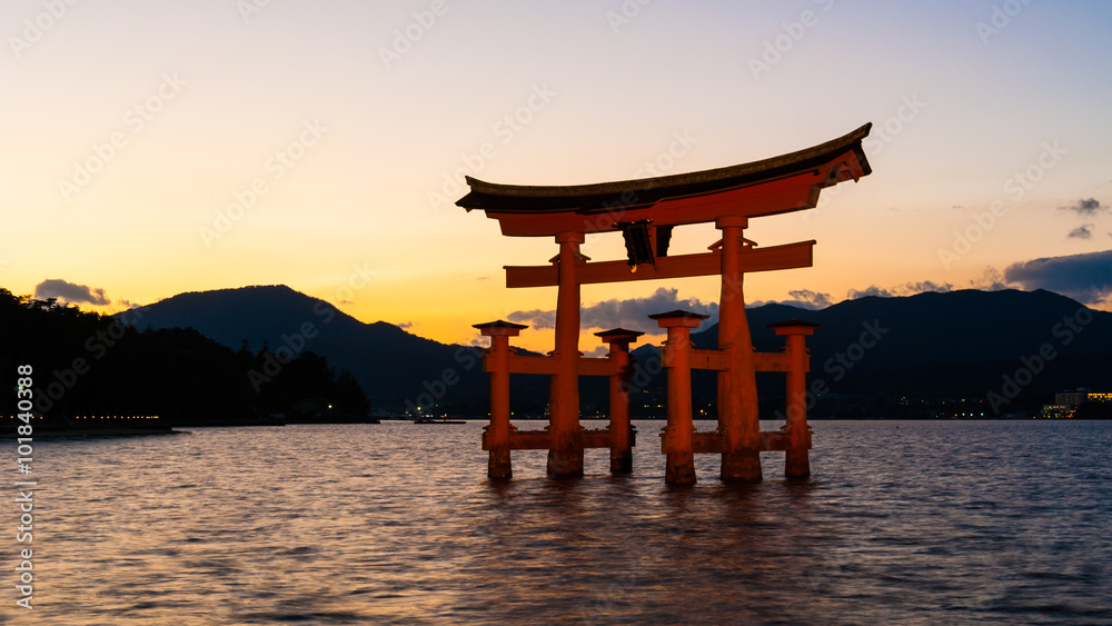 Itsukushima Shinto Shrine Torii Gate, Hiroshima, Japan - November 2010: Famous 'floating' torii gate of the Itsukushima Shinto Shrine beautifully lit as the sun sets. Itsukushima Shinto Shrine Torii Gate, Hiroshima, Japan - November 2010: Famous 'floating' torii gate of the Itsukushima Shinto Shrine beautifully lit as the sun sets.