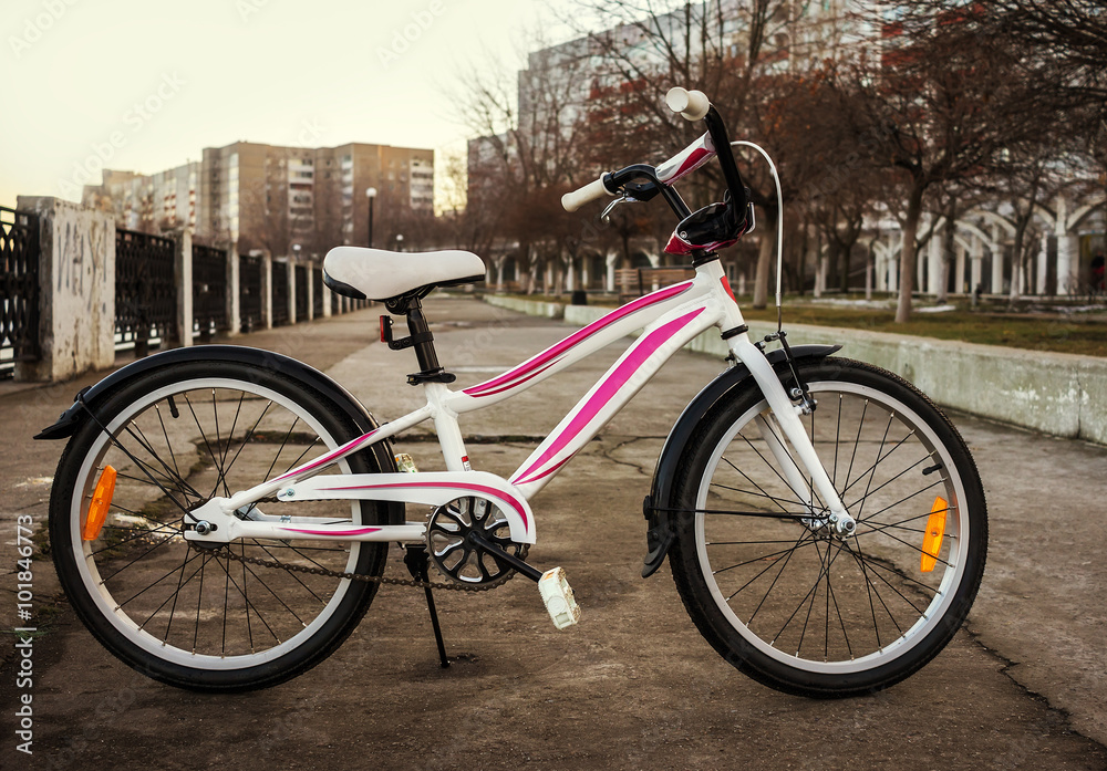Fototapeta premium Women's bike in a retro-style, white with pink stripes