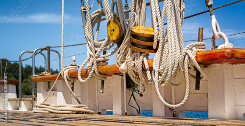 Nautical ropes and rigging on the deck of a wooden sailboat