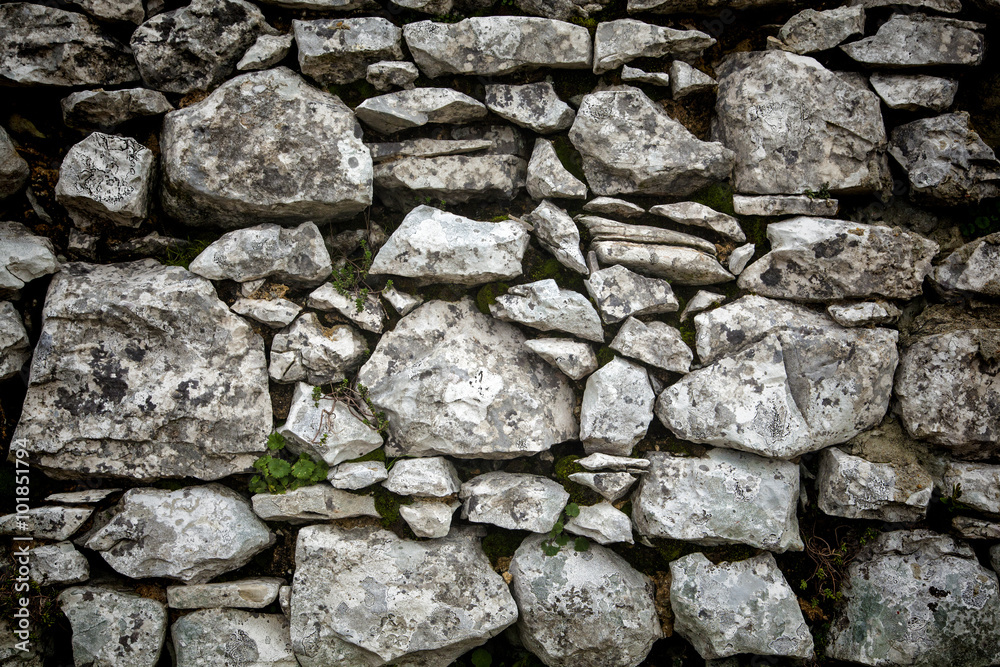 Fototapeta premium Grey textured stone wall with vignette effect