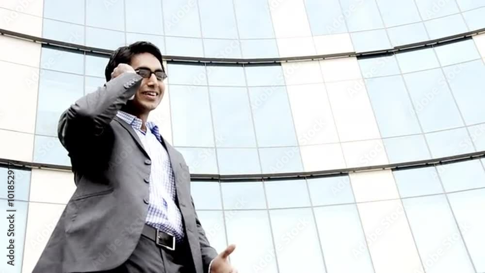 Shot of a smiling businessman talking on a mobile phone Shot of a smiling businessman talking on a mobile phone