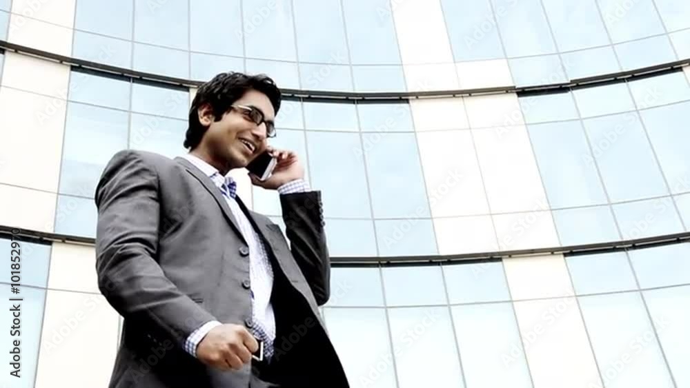 Shot of a smiling businessman talking on a mobile phone Shot of a smiling businessman talking on a mobile phone