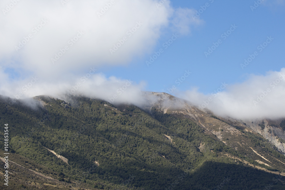 Clouds rolling over the hilltop