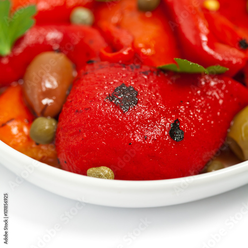 Roasted Red Pepper Salad on white background. Selective focus.