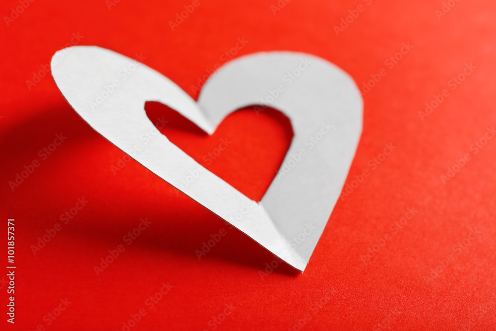 Cut out white paper heart on red background Cut out white paper heart on red background
