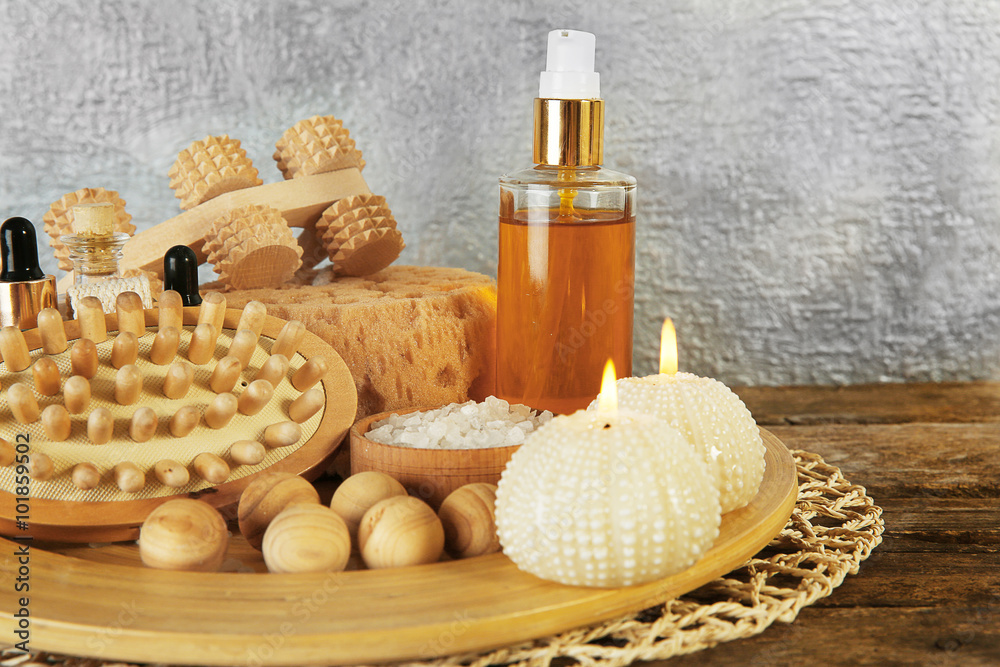 Variety of natural bath tools on wooden table, on grey wall background Variety of natural bath tools on wooden table, on grey wall background