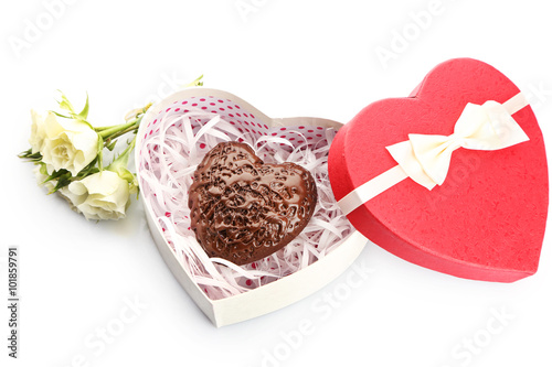 Heart shaped box and candy with flowers, isolated on white