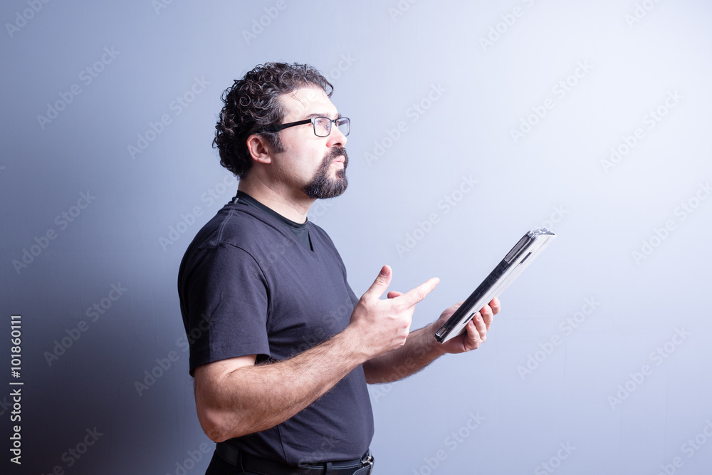 Thoughtful Man Holding Tablet and Counting on Hand Thoughtful Man Holding Tablet and Counting on Hand