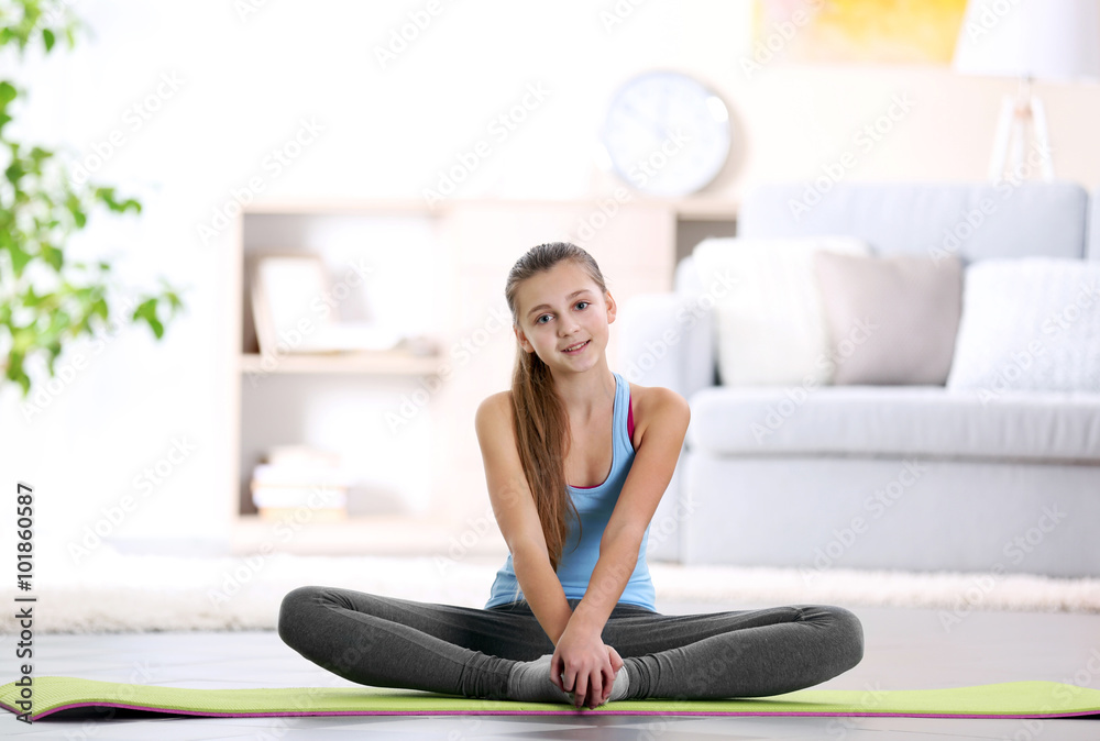 Young girl making fitness exercise indoors