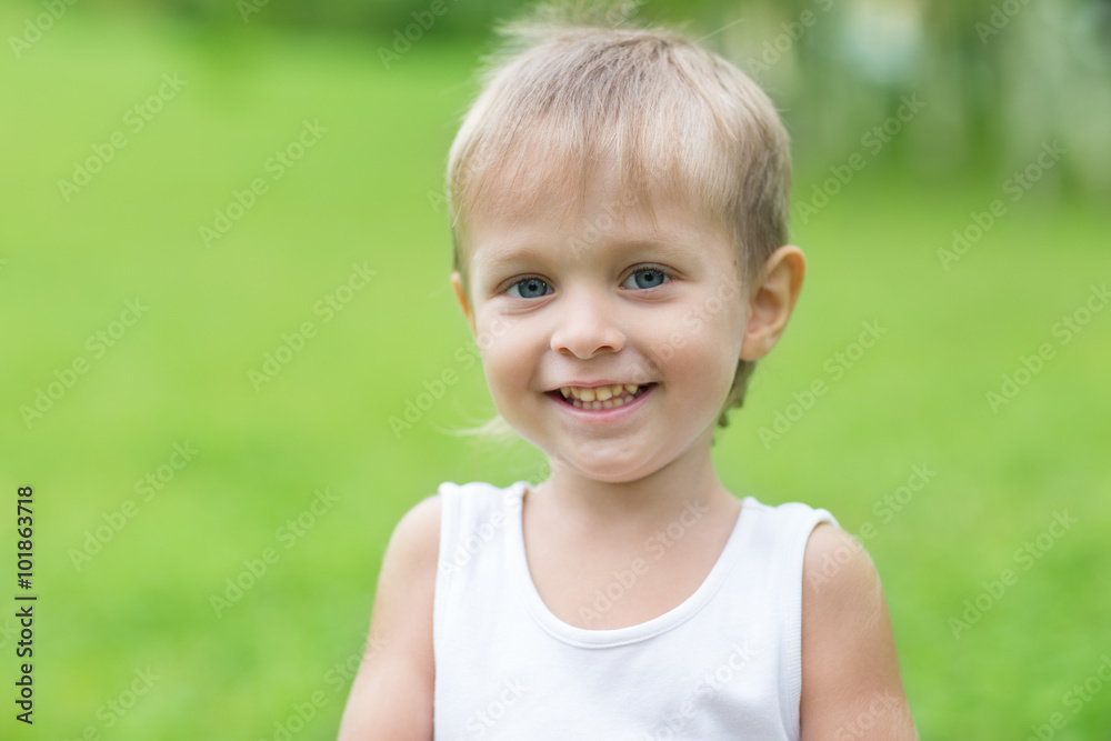 Cheerful boy on a background of green