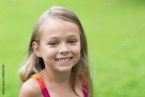 Charming little girl on a green background