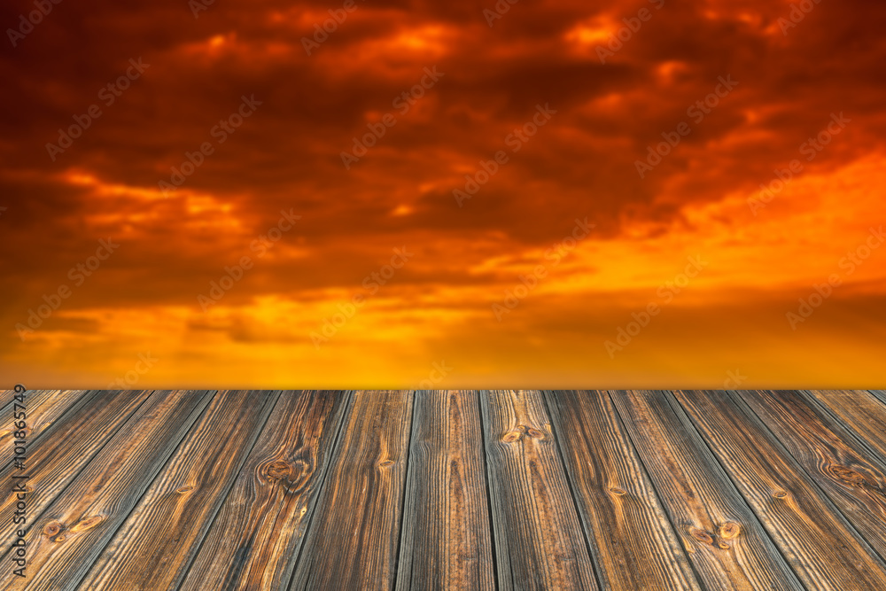 Empty wooden table and beautiful summer sunset in background. Gr