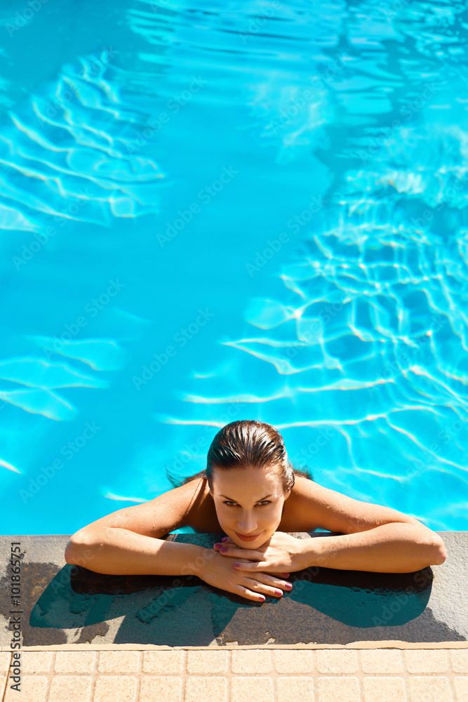 Summer Travel Vacation. Beautiful Sexy Young Woman Relaxing In Swimming Pool ( Water ) At Resort Spa Hotel. Health Care, Beauty Concept. Healthy Lifestyle, Wellness. Body Care. Freshness Concept. 