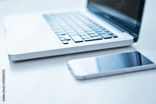 Close-up open laptop and smartphone on the table