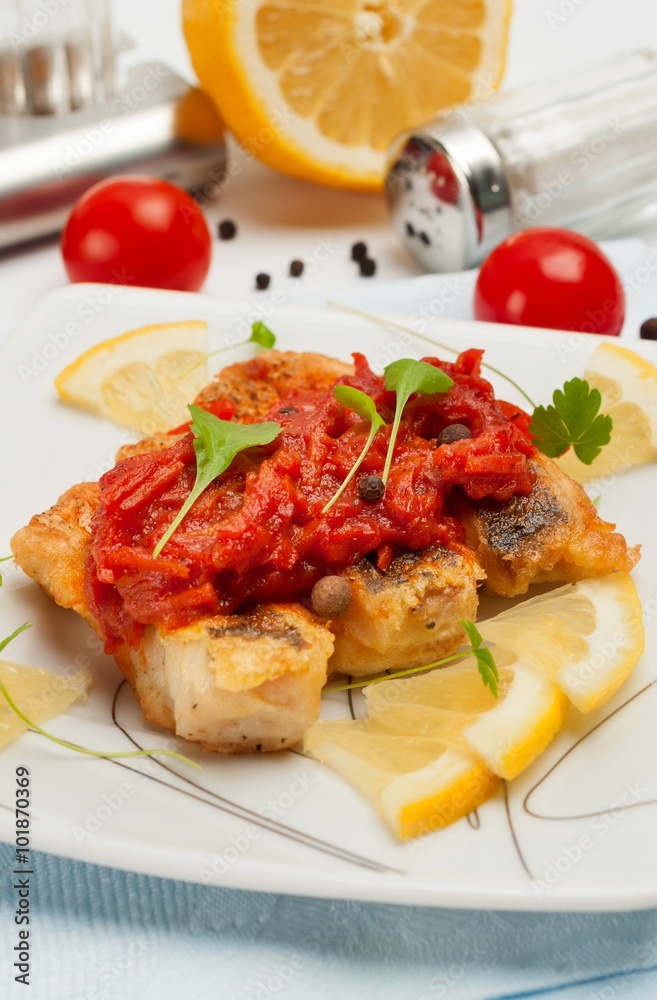 Pieces of fried fish with vegetable marinade.