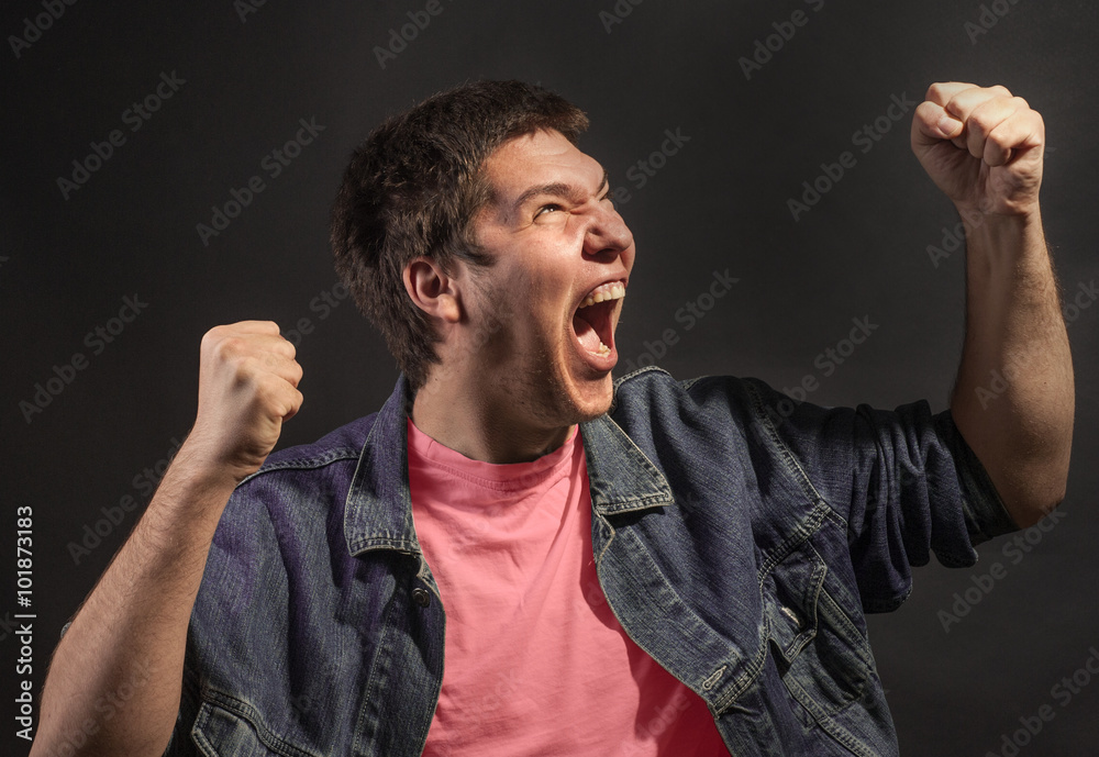 Close-up of a man screaming in agony.