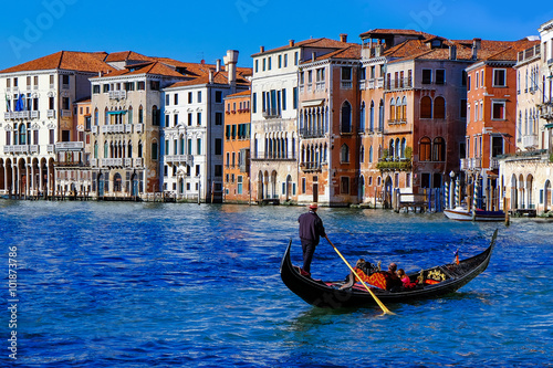 Gondola on Canal Grande with Classic old house in the background © sahachat