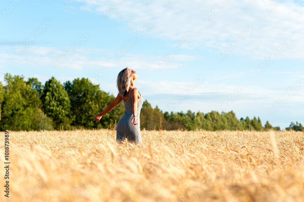 Young cheerful woman her face upward with opened outstretched ar Young cheerful woman her face upward with opened outstretched ar