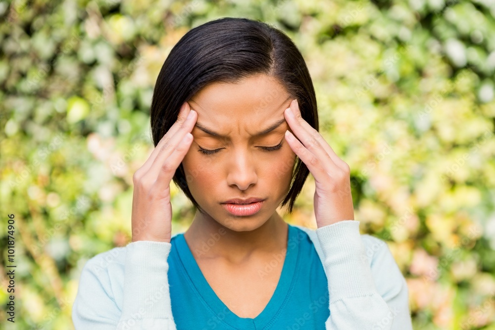 Portrait of frowning brunette with headache Portrait of frowning brunette with headache