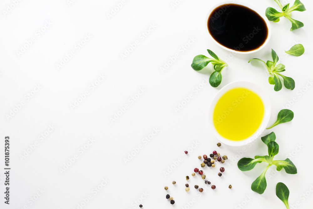 Obraz premium Healthy food background with olive oil, balsamic, cornsalad and colorful spices on white backdrop.Detox and diet concept. 