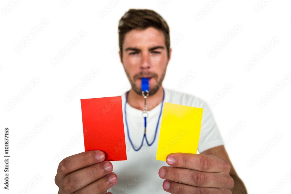 Handsome supporter showing red and yellow cards Handsome supporter showing red and yellow cards