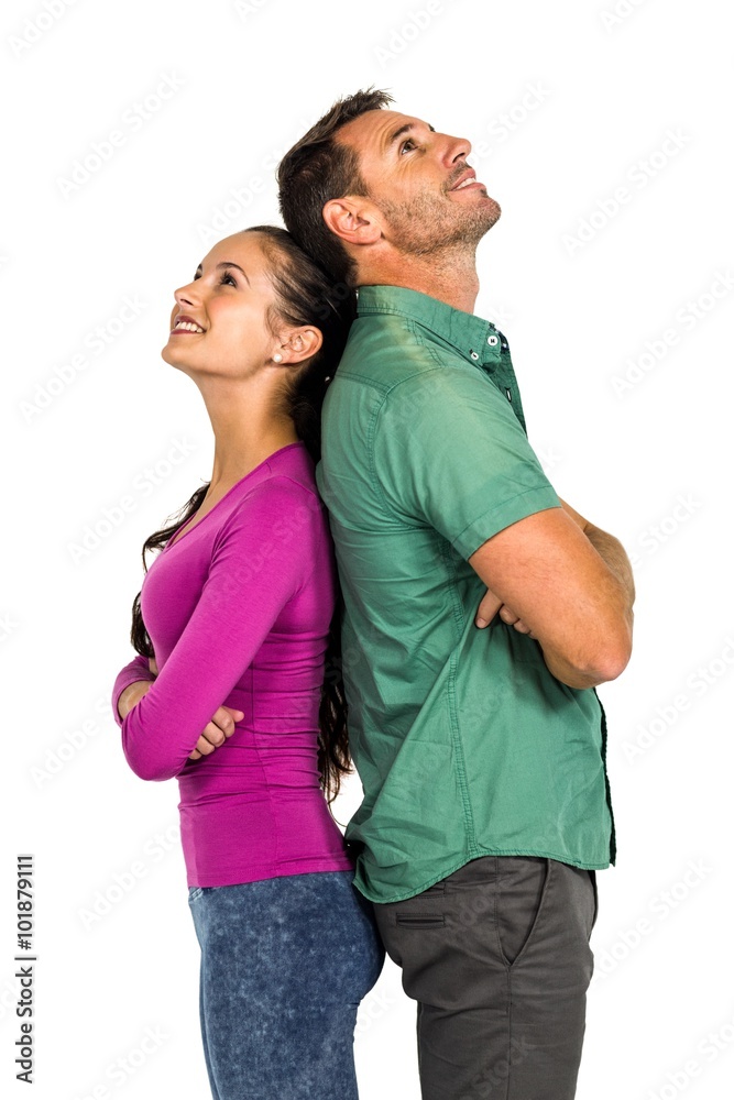 Couple standing back to back land looking up Couple standing back to back land looking up