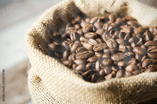 Close up coffee beans in jute bag © Proxima Studio