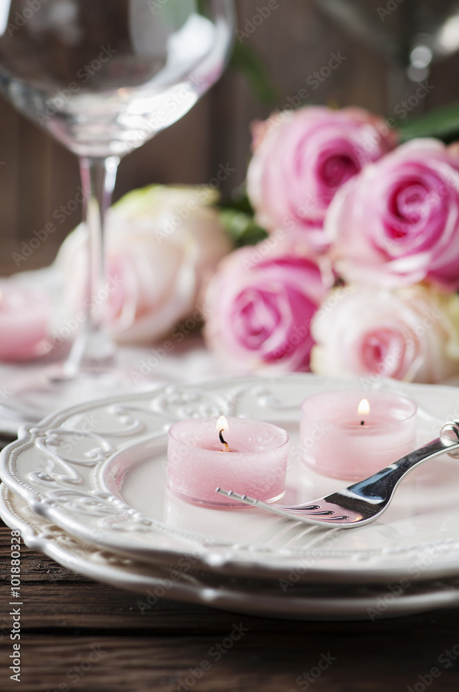 Pink candle and roses on the table Pink candle and roses on the table