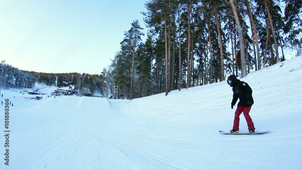 Snowboarder doing a stunt in the park Snowboarder doing a stunt in the park