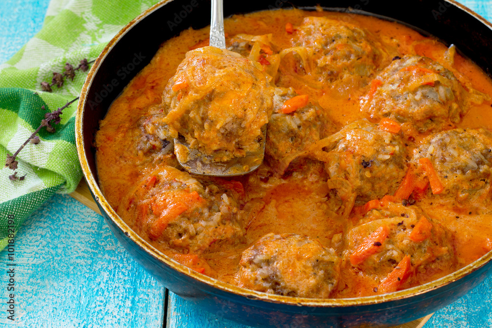 Homemade meatballs in tomato sauce with basil and spices in a fr Homemade meatballs in tomato sauce with basil and spices in a fr