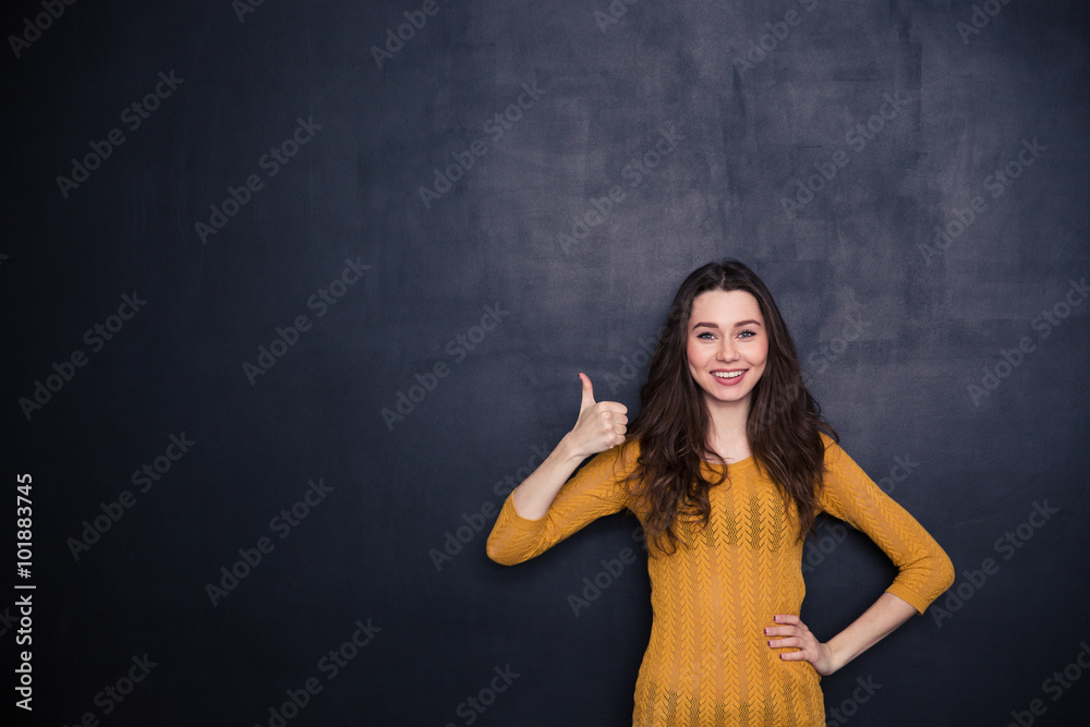 Smiling casual woman showing thumb up Smiling casual woman showing thumb up