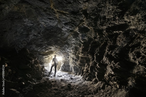 Man explores a cave photo