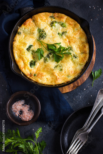 frittata (omelette) with vegetables and cheese in cast iron pan