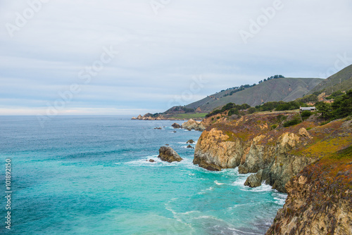 Benches facing the coastline in route 1 California , USA