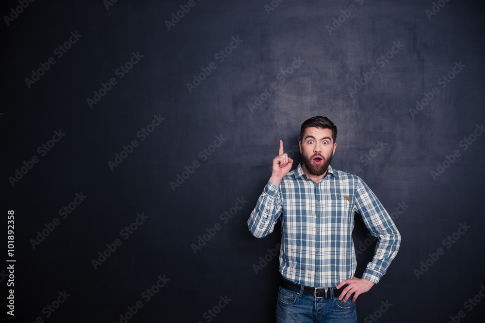 Man showing finger up over black background