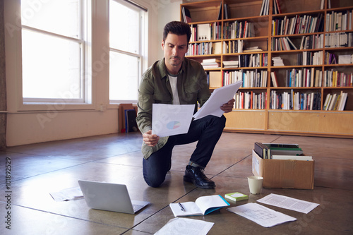 Businessman Laying Documents On Floor To Plan Project