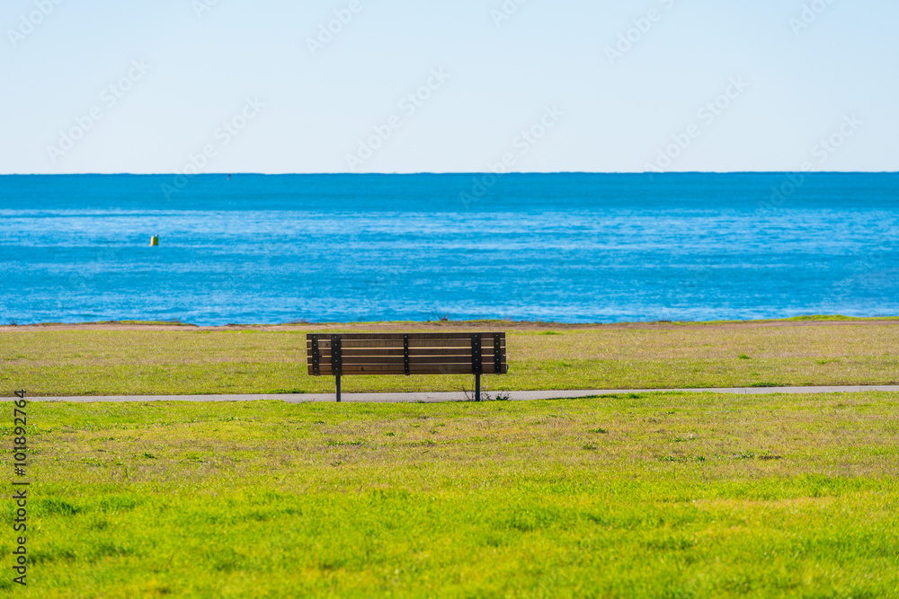 Benches facing the coastline in route 1 California , USA Benches facing the coastline in route 1 California , USA