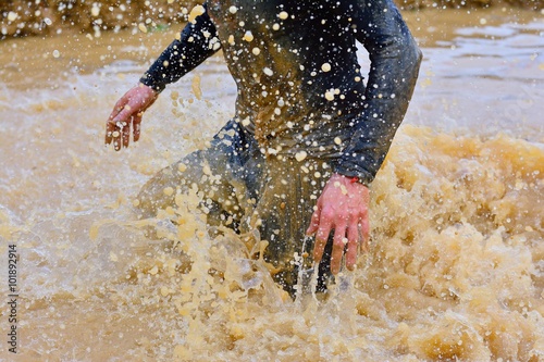 Close-up of man making splashes of dirty water