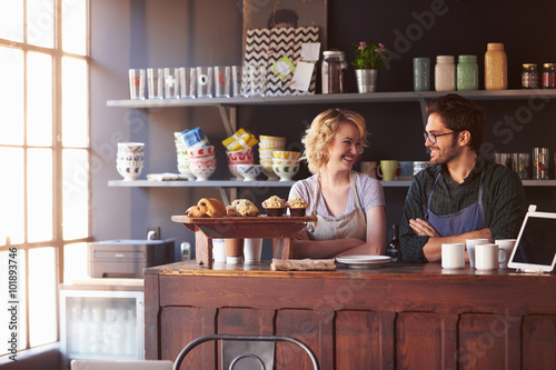 Couple Running Coffee Shop Standing Behind Counter