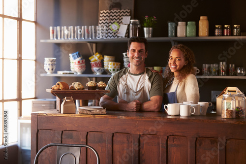 Portrait Of Couple Running Coffee Shop Behind Counter