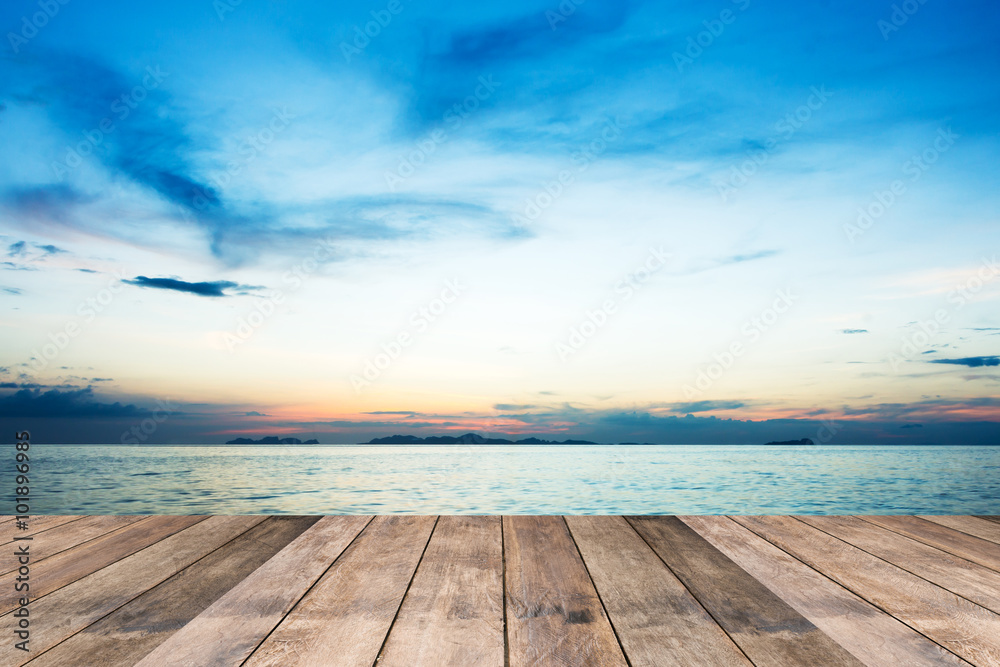 Perspective of wood terrace against beautiful seascape at sunset