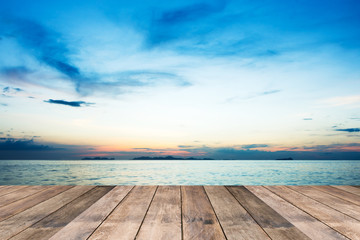 Perspective of wood terrace against beautiful seascape at sunset